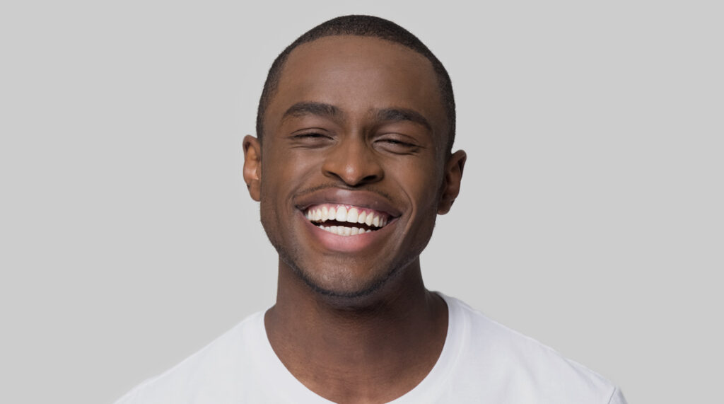 man smiling benefits of getting veneers
