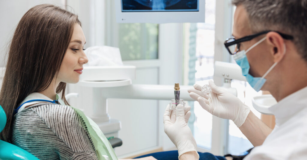 woman at dentists implant showing additional costs