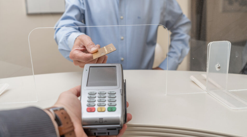 man at dentists paying integrating payment plans