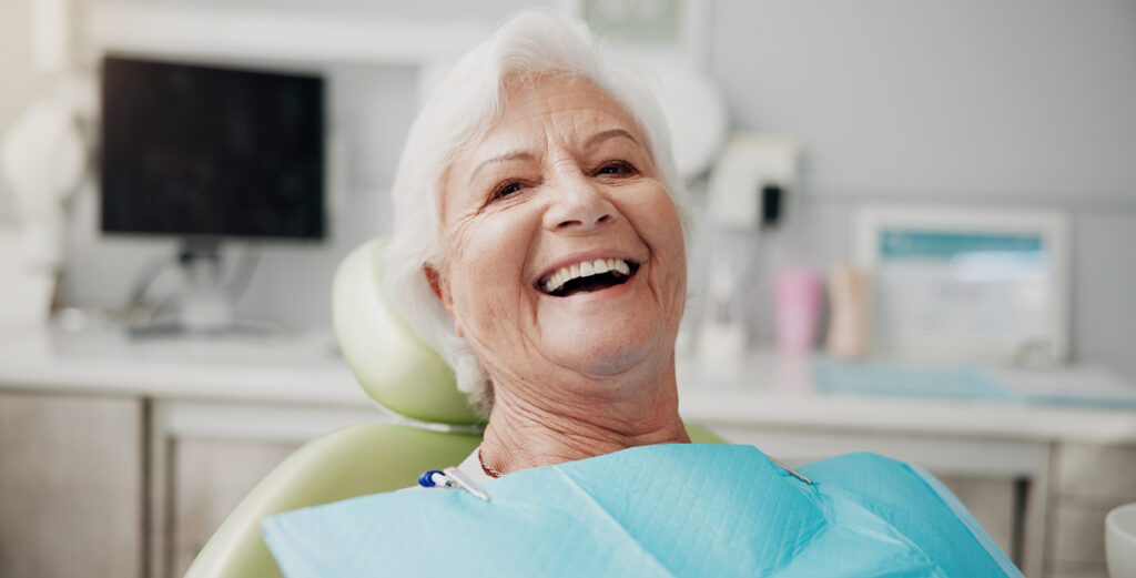woman in dental chair smiling treatment process of replace a lost tooth
