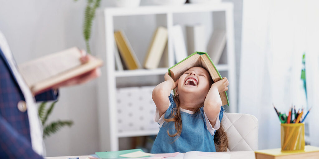 Child playing with book at private autism assessment